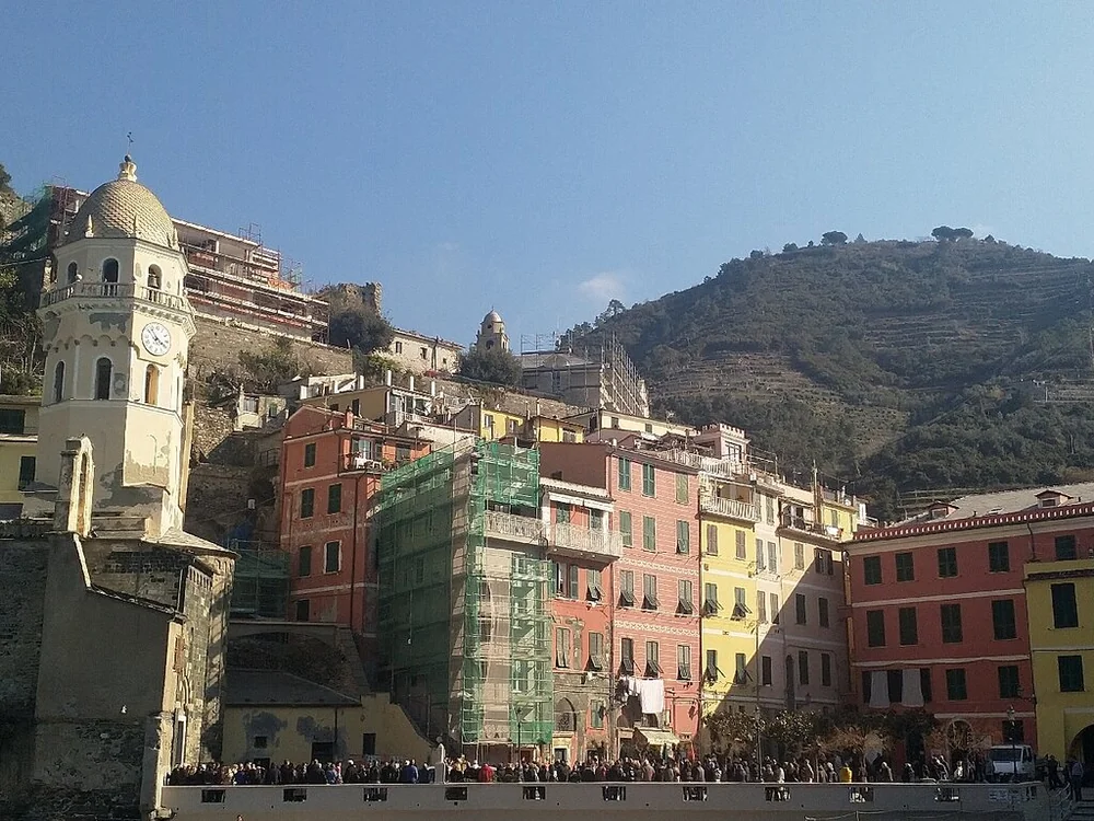 Vernazza's harbour square with the church tower and coloured houses